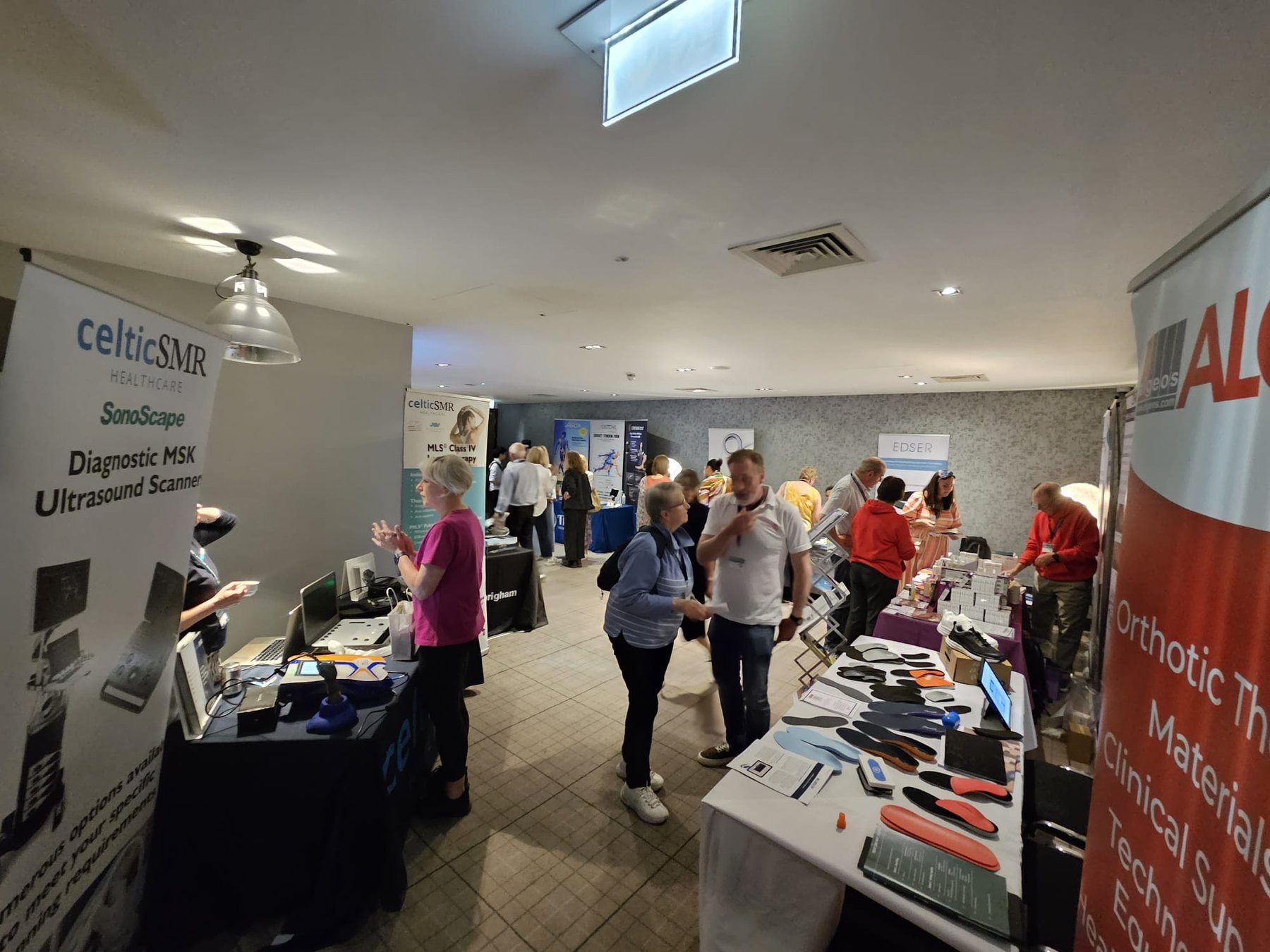 Conference attendees networking around exhibitor stands
