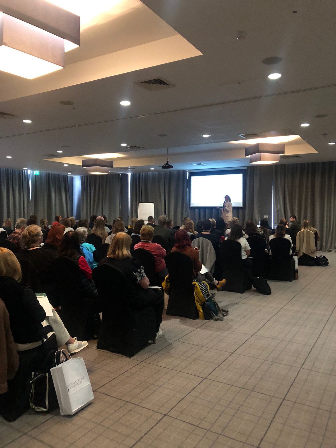 Podiatry community event with an audience listening to a speaker